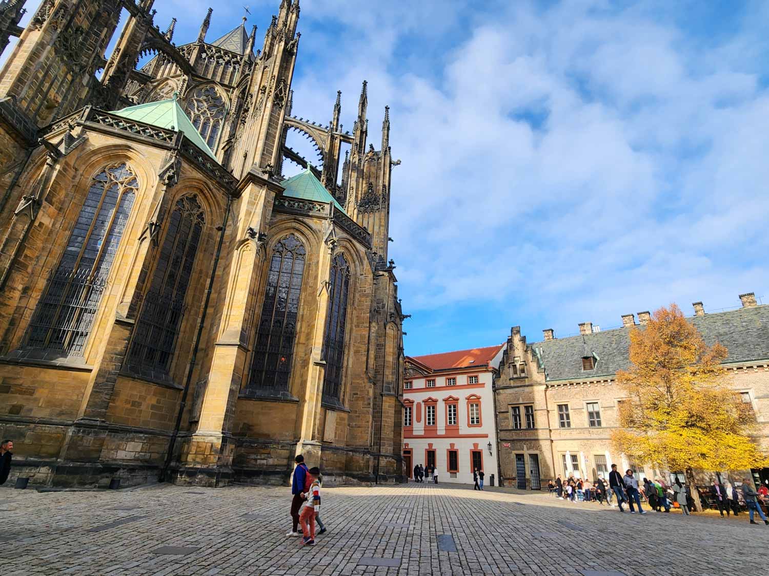 Exterior of St Vitus Cathedral and some of the buildings in the Prague castle complex on a sunny autumn day - the castle is one of the unmissable things to do in Prague with kids