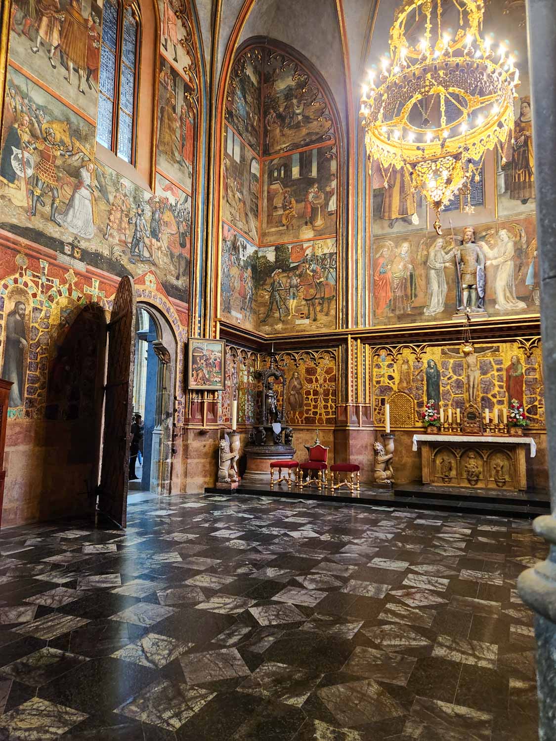 Ornate painted interior of St Vitus cathedral in the Prague Castle complex - one of the historic places to visit in Prague with kids