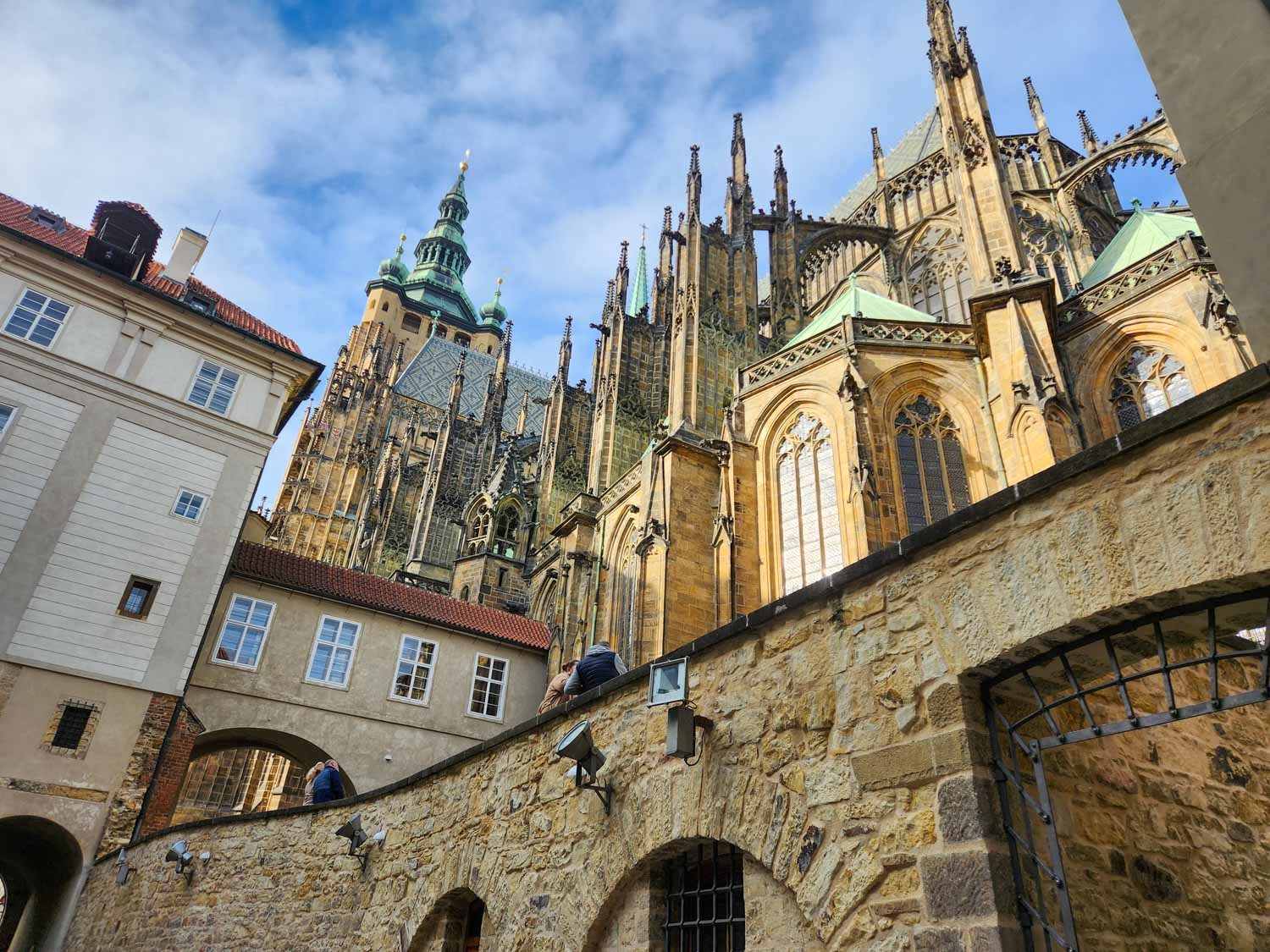 View up from a lower level to the towers and buttresses of St Vitus cathedral inside the Prague castle complex - one of the best places to visit in Prague with kids