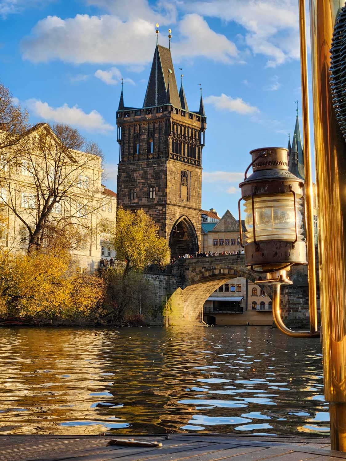 View of one of the towers on the Charles Bridge from a Vltava boat cruise - one of the fun things to do in Prague with kids