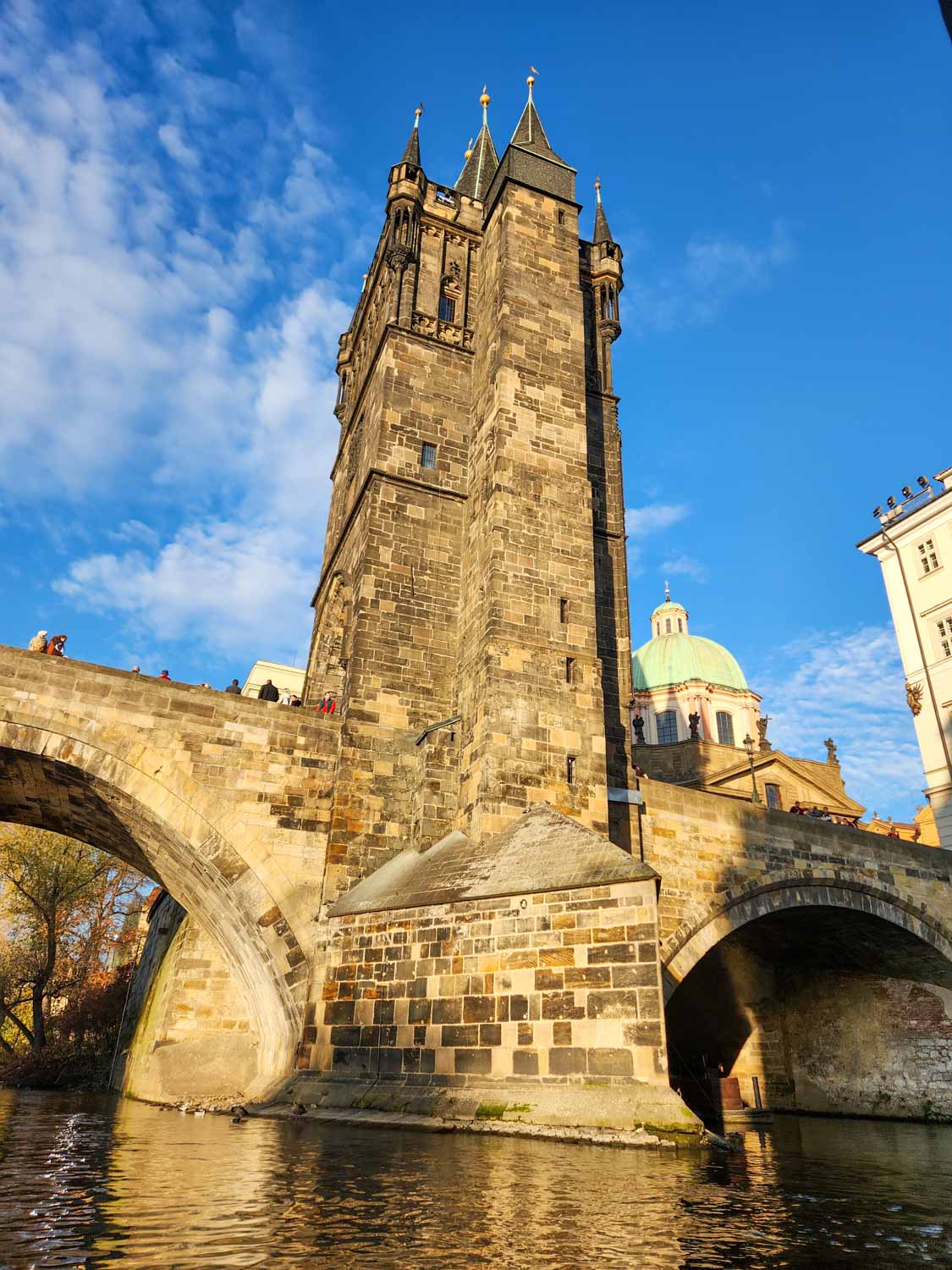 View of one of the towers on Charles Bridge, seen from the river - climbing the tower gives one of the best views of Prague with kids