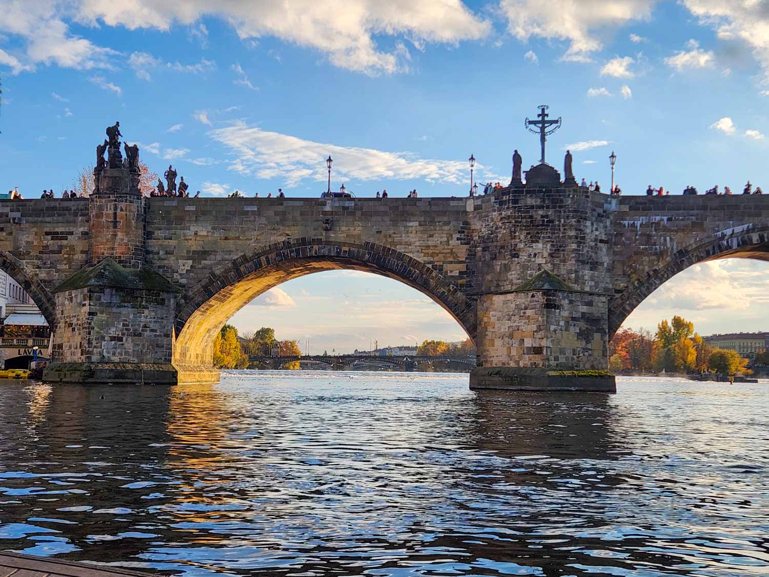 View of the Charles Bridge and its statues from the Vltava River - one of the best things to do in Prague with kids