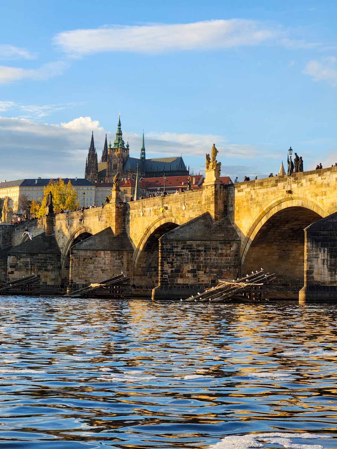 View up to the Charles Bridge with the spires of Prague visible in the background during a holiday in Prague with kids