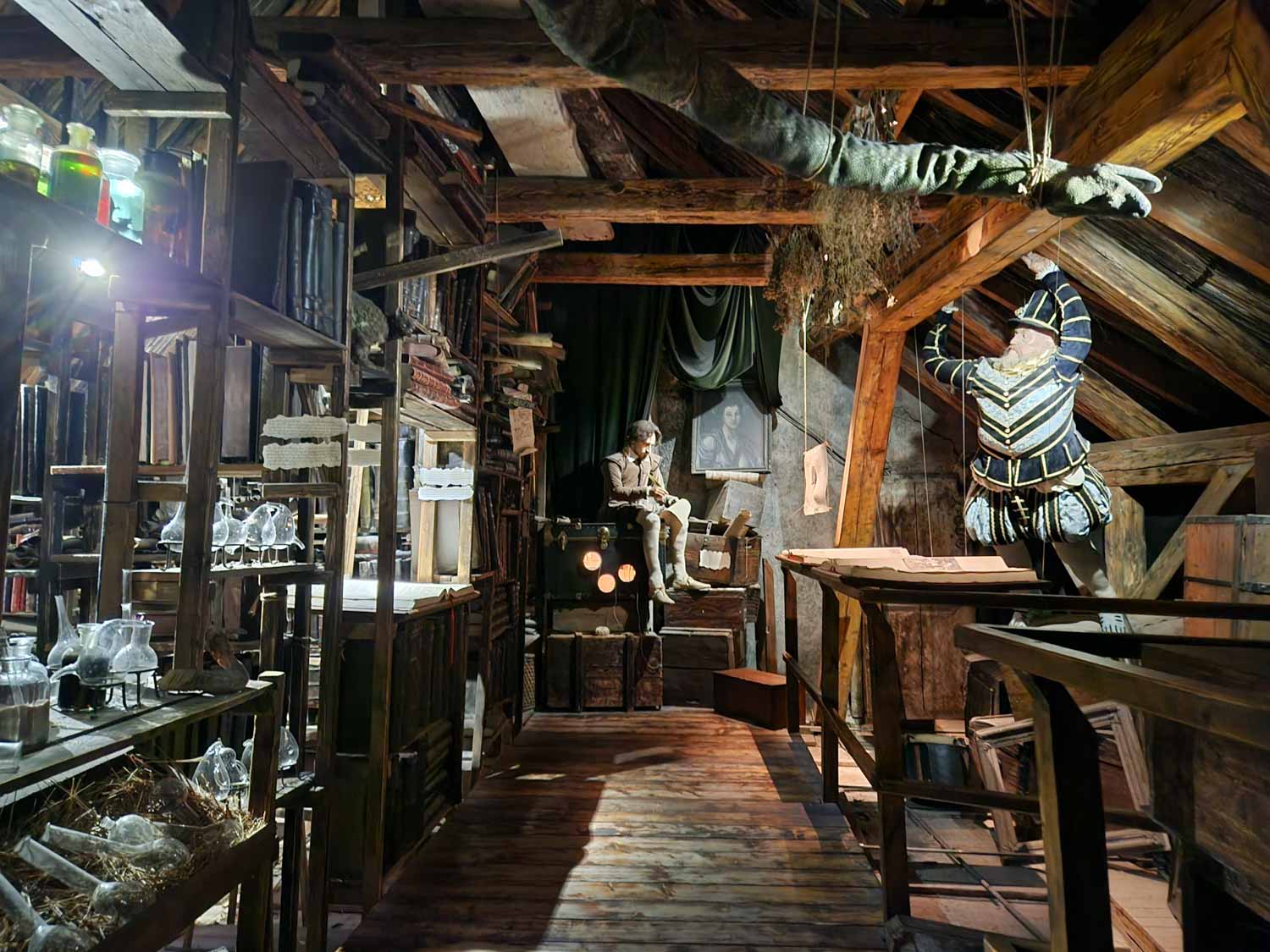 Attic room with various figures and alchemy paraphernalia at the Prague Museum of Alchemists and Magicians - one of the most unusual things to do in Prague with kids