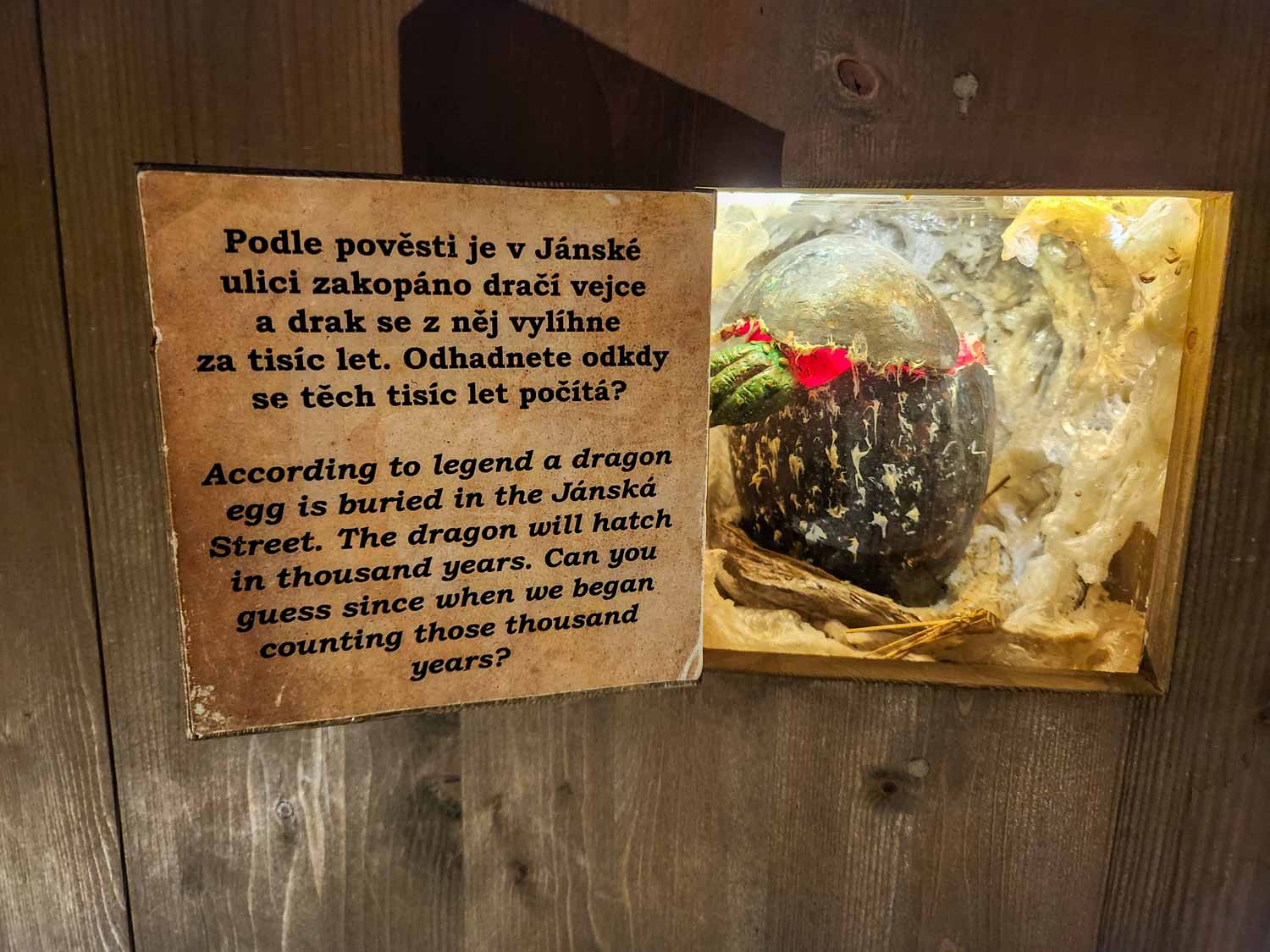 Display about a legend of a dragon egg supposedly buried in Prague at the Museum of Prague Ghosts and Legends - one of the most unusual things to do with kids in Prague