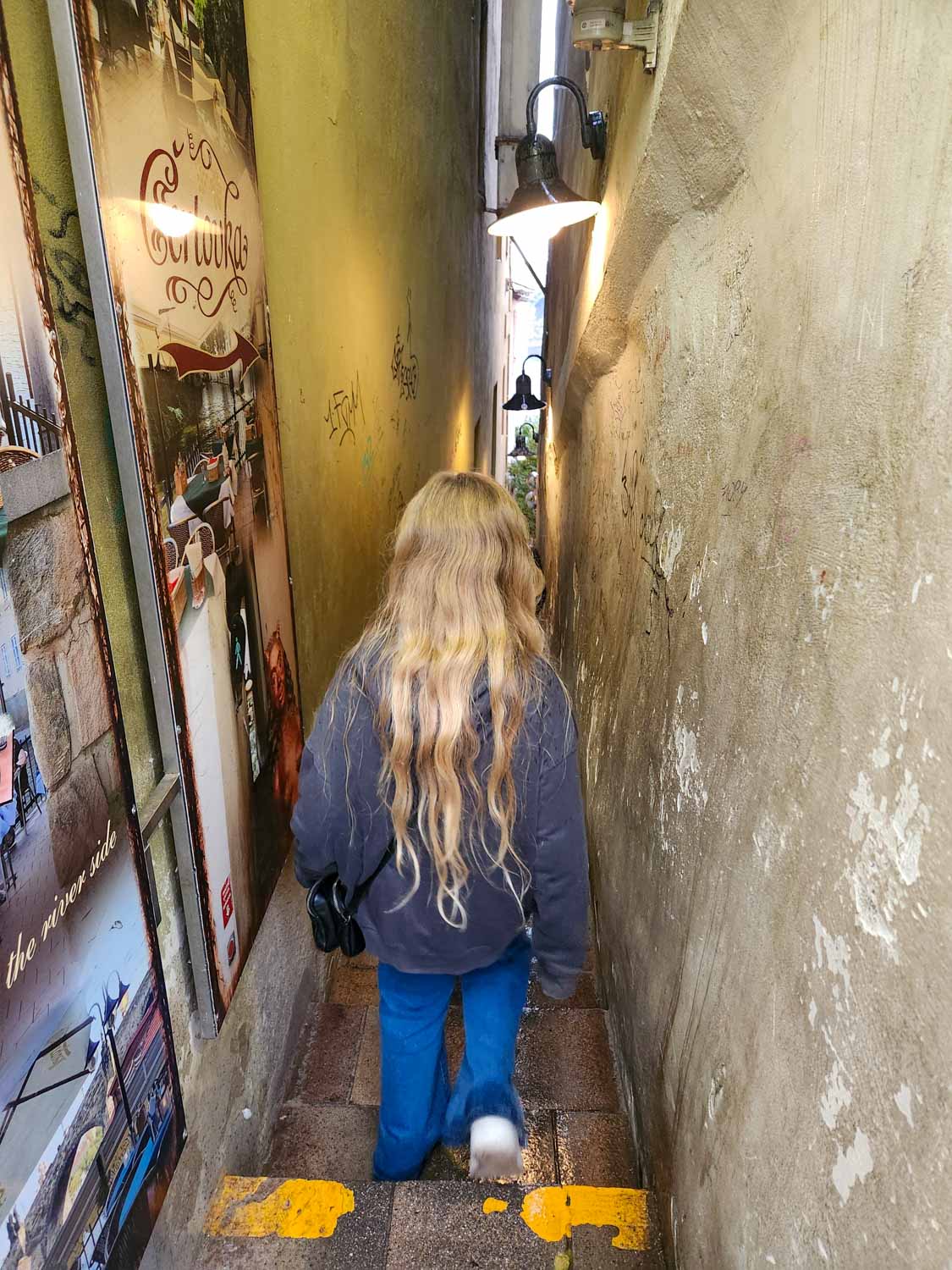 My daughter steps down into Prague's narrowest alley - one of the quirky things to do in Prague with children