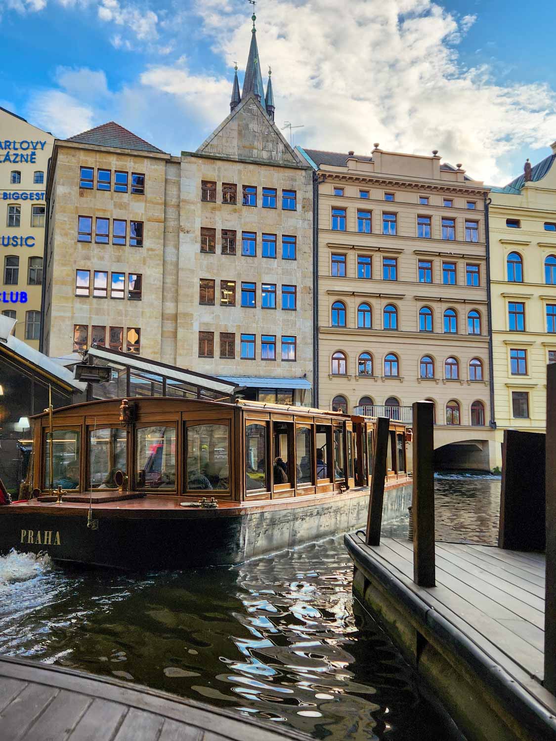 View of one of the traditional wooden boats which take cruises on the Vltava river - one of the best ways to see Prague with kids