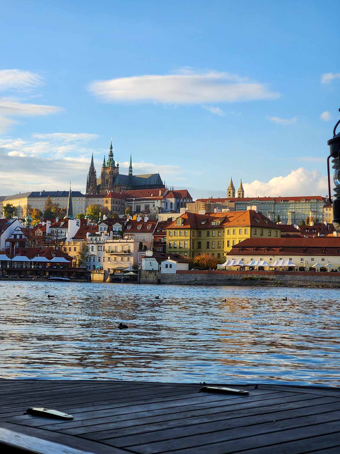 View towards St Vitus cathedral and the castle during a boat trip in Prague with kids