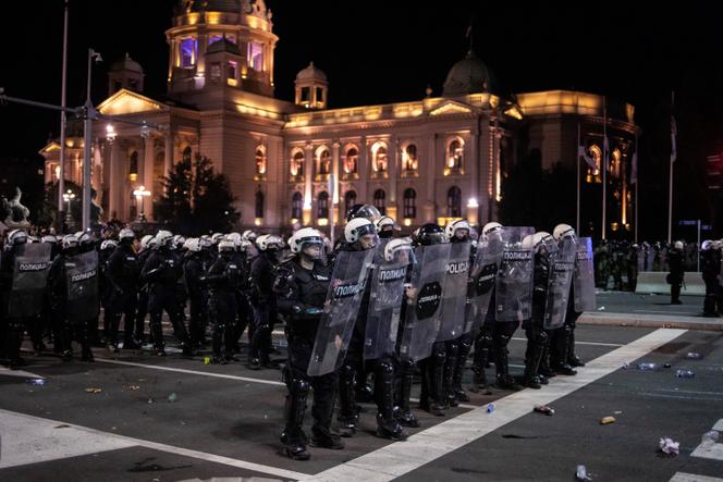 Law enforcement officers in riot gear stand guard near the parliament building in Belgrade, Serbia, November 2, 2025. 