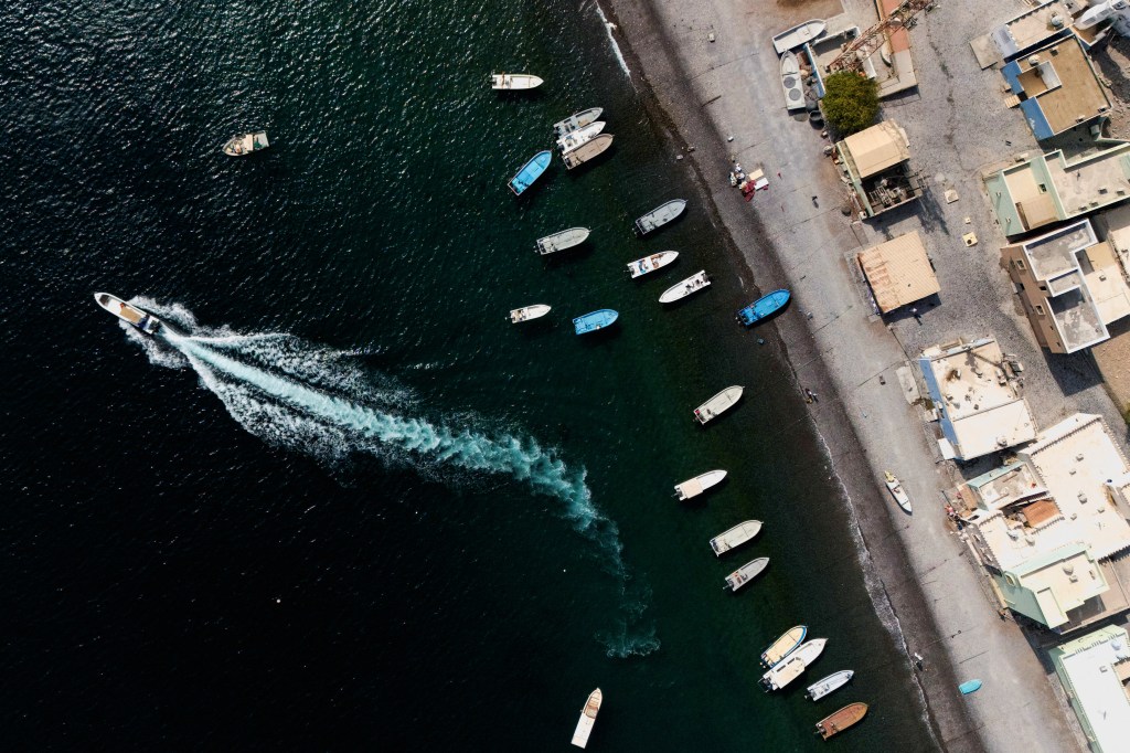 Drone view of a boat departing from Kumzar, a village in Oman overlooking the Strait of Hormuz.It marked the first confirmed capture of a commercial vessel by Tehran since its June clashes with Israel and the United States.