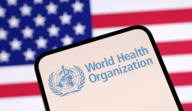 World Health Organization (WHO) logo and U.S. flag are seen in this illustration taken April 23, 2025. REUTERS/Dado Ruvic/Illustration