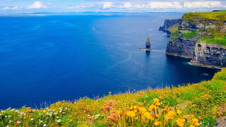 Beautiful view of the Cliffs of Moher, a calm blue sea with copy space.