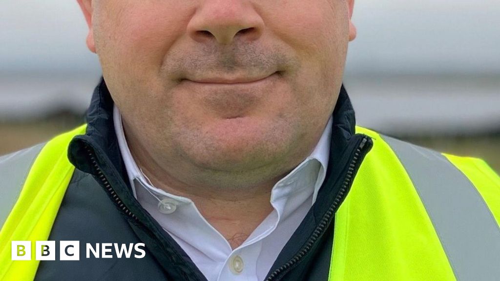 A man wearing a hi-vis jacket