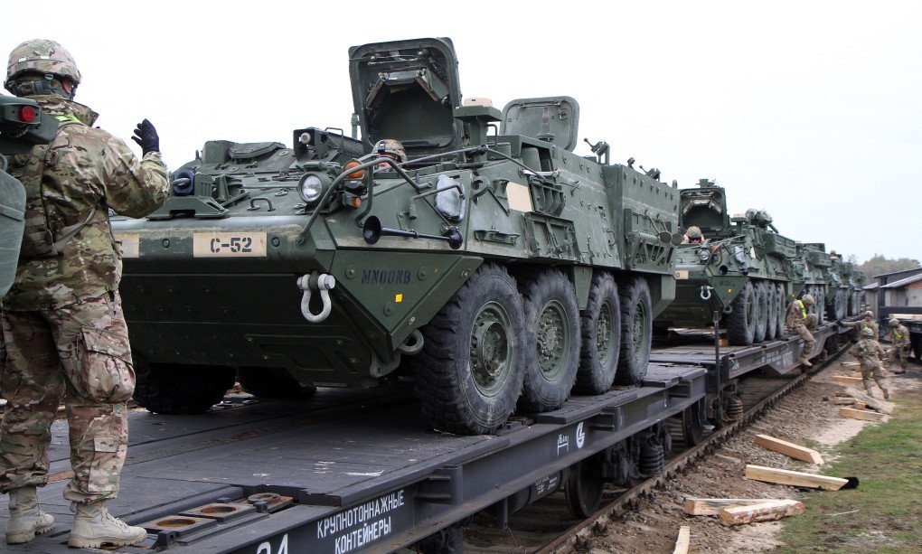 Members of the US Army 1st Brigade, 1st Cavalry Division, unload Stryker Armored Vehicles at the railway station near the Rukla military base in Lithuania, on October 4, 2014. (Source: Getty Images)