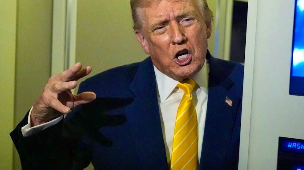 US President Donald Trump speaks to reporters on Air Force One on the way to his Mar-a-Lago estate. Photo: Manuel Balce Ceneta/AP/dpa