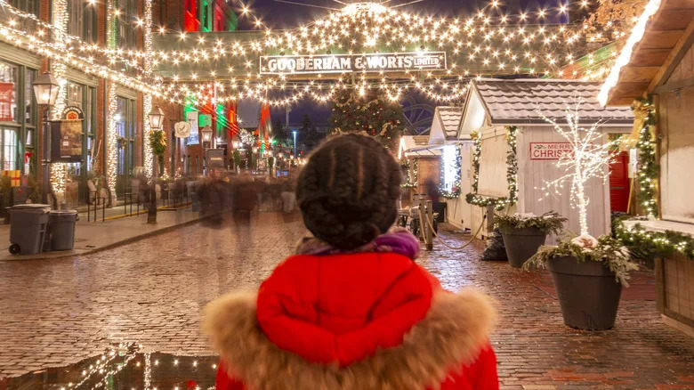 A woman looking at the lights in Distillery Winter Village