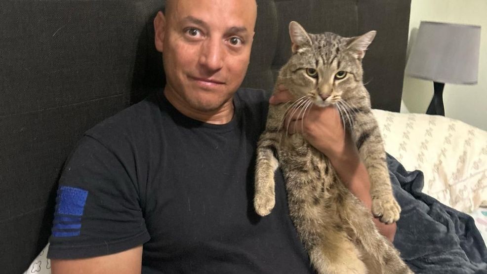 U.S. Army Warrant Officer CW2 Richard DeJesus reunited with Polish stray cat "Pluto."{ } Credit: SPCA International