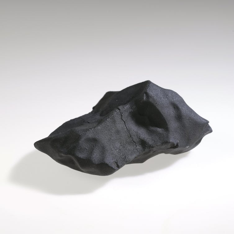 Dark black rock with smooth bumpy surface