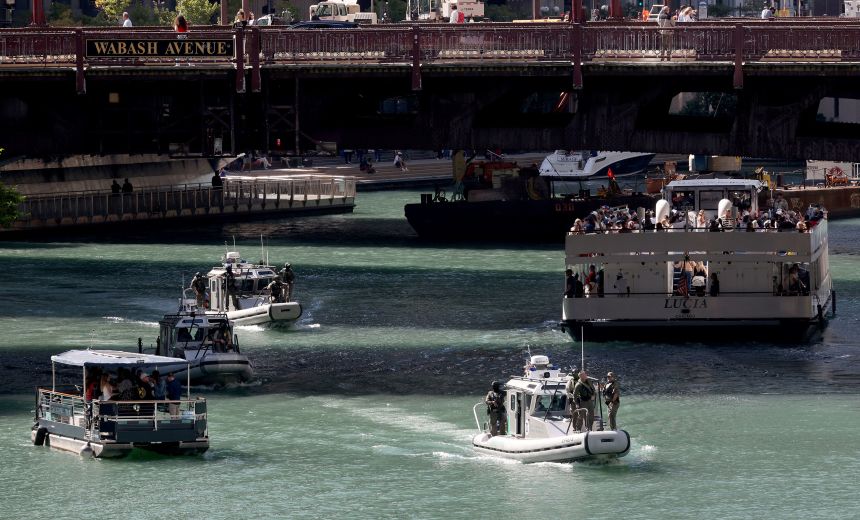 US Customs and Border Protection boats (center) with armed agents patrol the downtown section of the Chicago River on September 25.