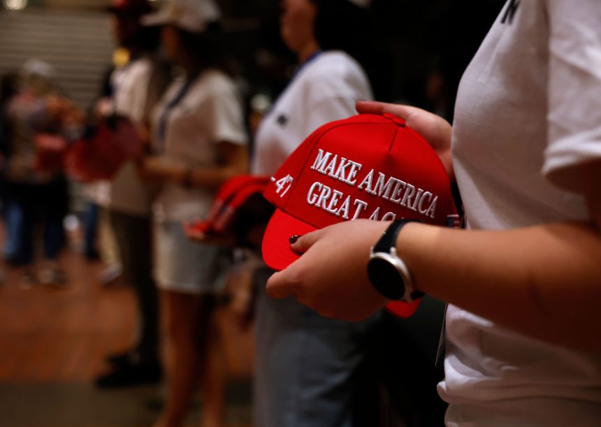 Volunteers pass out Make America Great Again merchandise at a Turning Point USA event at the University of California, Berkeley on November 10, 2025.