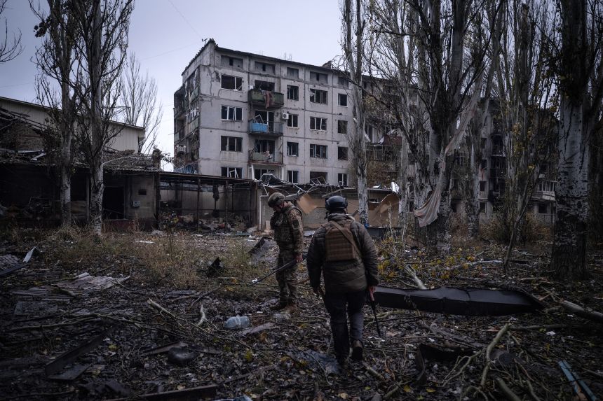 This handout photograph, taken on November 12, 2025, shows Ukrainian servicemen checking the area next to destroyed buildings in the frontline town of Kostyantynivka.