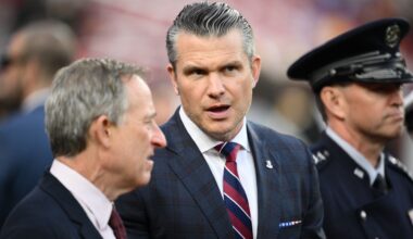 Defense Secretary Pete Hegseth is seen on the sidelines before an NFL football game between the Washington Commanders and the Detroit Lions Sunday, Nov. 9, 2025, in Landover, Md. (AP Photo/Nick Wass)