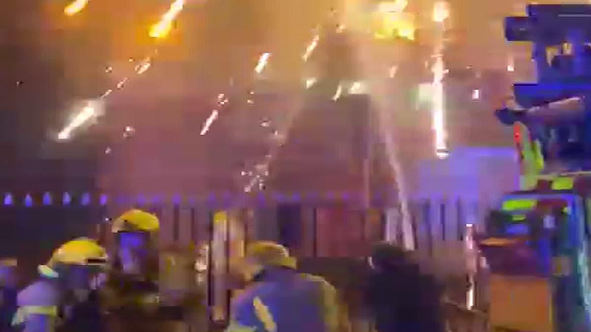 Bonfire night horror as youths set tower block alight with fireworks then shoot rockets at 999 crews battling inferno: Boy, 14, arrested 'for trying to kill'