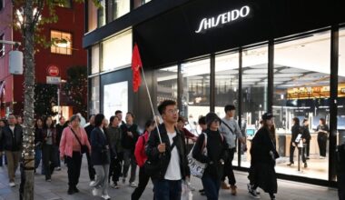 A Chinese tour group walks past a Shiseido store in Tokyo