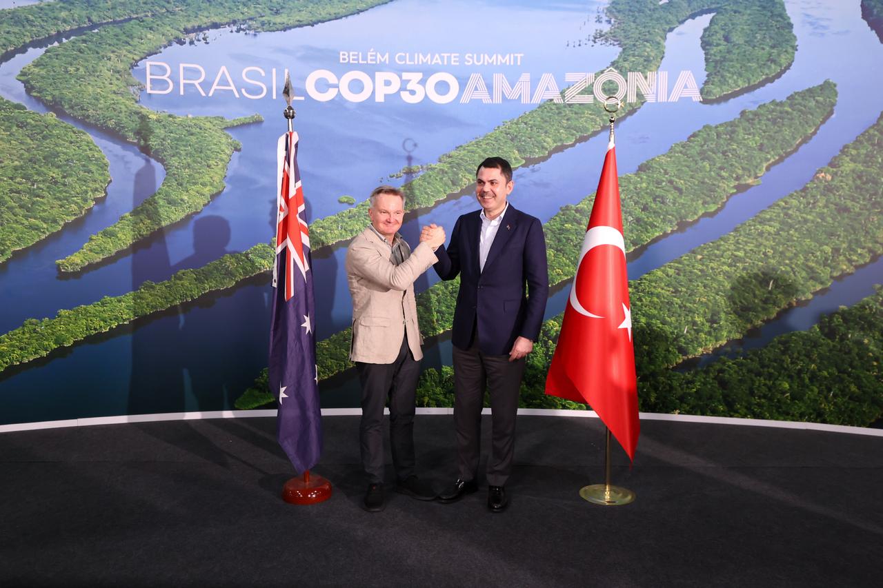 Turkish Ministry of Environment and Urbanization Murat Kurum shakes hands with the Minister for Climate Change and Energy of Australia, Chris Bowen, at the 30th Conference of the Parties (COP30) to the UN Framework Convention on Climate Change (UNFCCC) in Belem, Brazil on Nov. 22, 2025. (AA Photo)