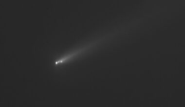 a black and white image of a comet streaking through outer space