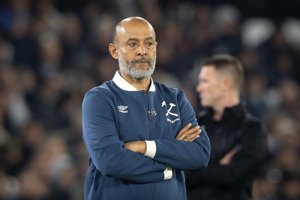 Nuno Espirito Santo crosses his arms on the touchline as he manages a West Ham game against Brentford.