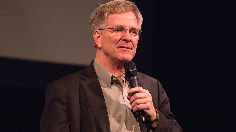 TV personality Rick Steves speaking into a microphone