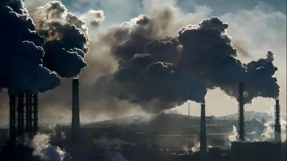 Smoke billows from industrial stacks on the outskirts of an Iranian city during a week of hazardous air pollution