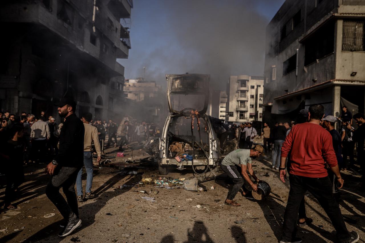 A view of the site as Palestinians try to inspect and rescue the dead bodies of victims from a burning vehicle after Israeli forces bombed a vehicle in the al-Abbas area in Gaza City, Gaza on Nov. 22, 2025. (AA Photo)