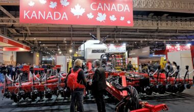 farm equipment on display at an indoor pavilion