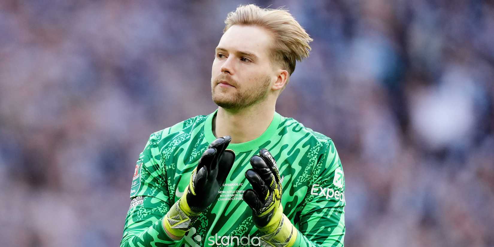 Caoimhin Kelleher applauding the Liverpool supporters