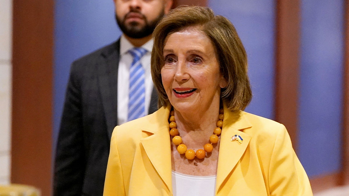 Rep. Nancy Pelosi wearing a yellow jacket