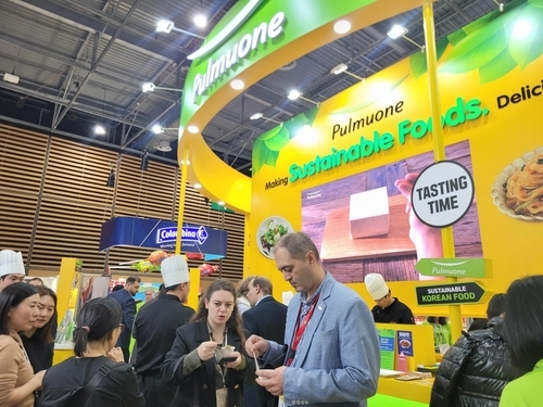 Foreign buyers and consumers visit the Pulmuone booth to sample plant-based products such as tofu tenders and soy milk noodles at the food fair "Sial Paris 2024" in Paris, France, last year.