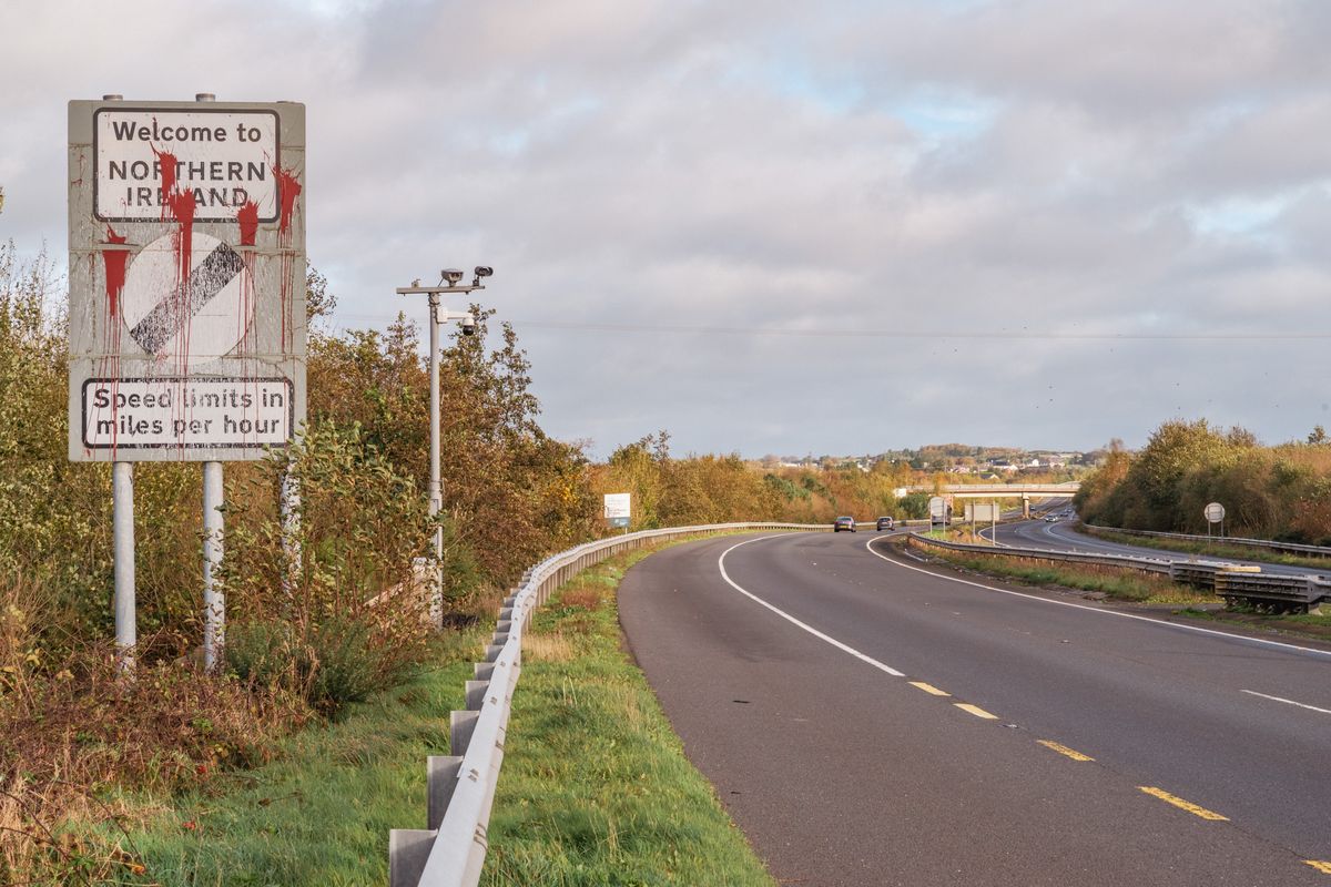 Open road and Northern Ireland welcome sign at border with the Republic