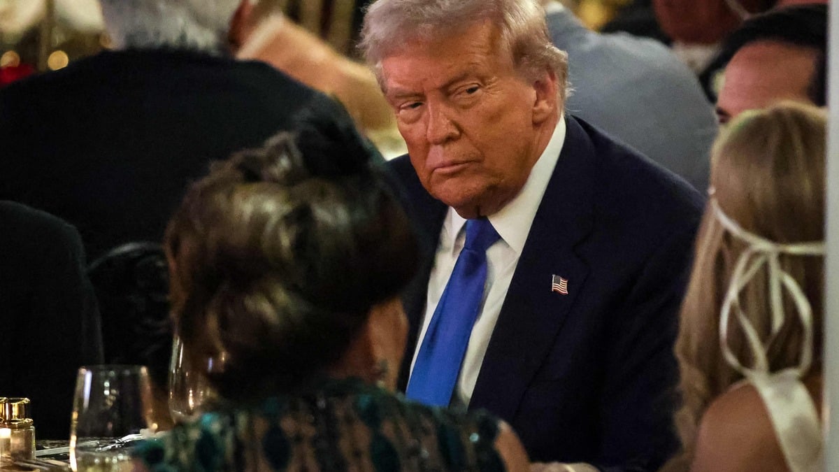 US President Donald Trump talks with guests during a Halloween party at his Mar-a-Lago estate on October 31, 2025 at Palm Beach, Florida.