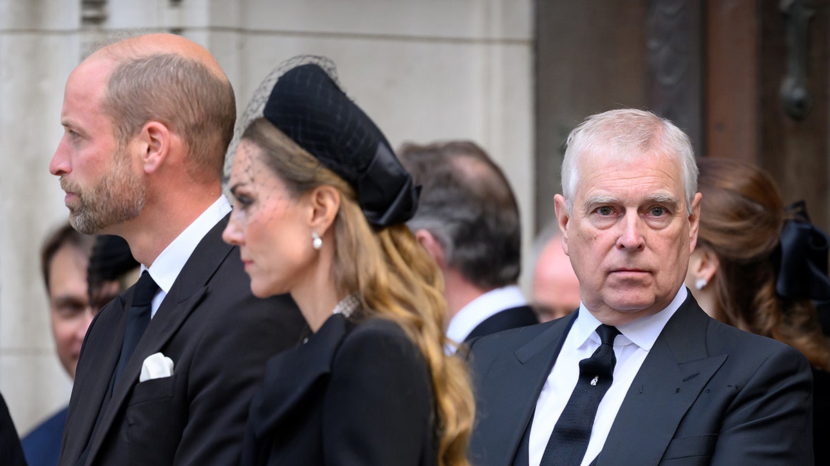 Prince William and Kate Middleton looking away from Prince Andrew as he looks on.