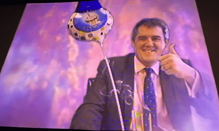 The Embassy's big screen shows Chris Bishop throwing a thumbs up.