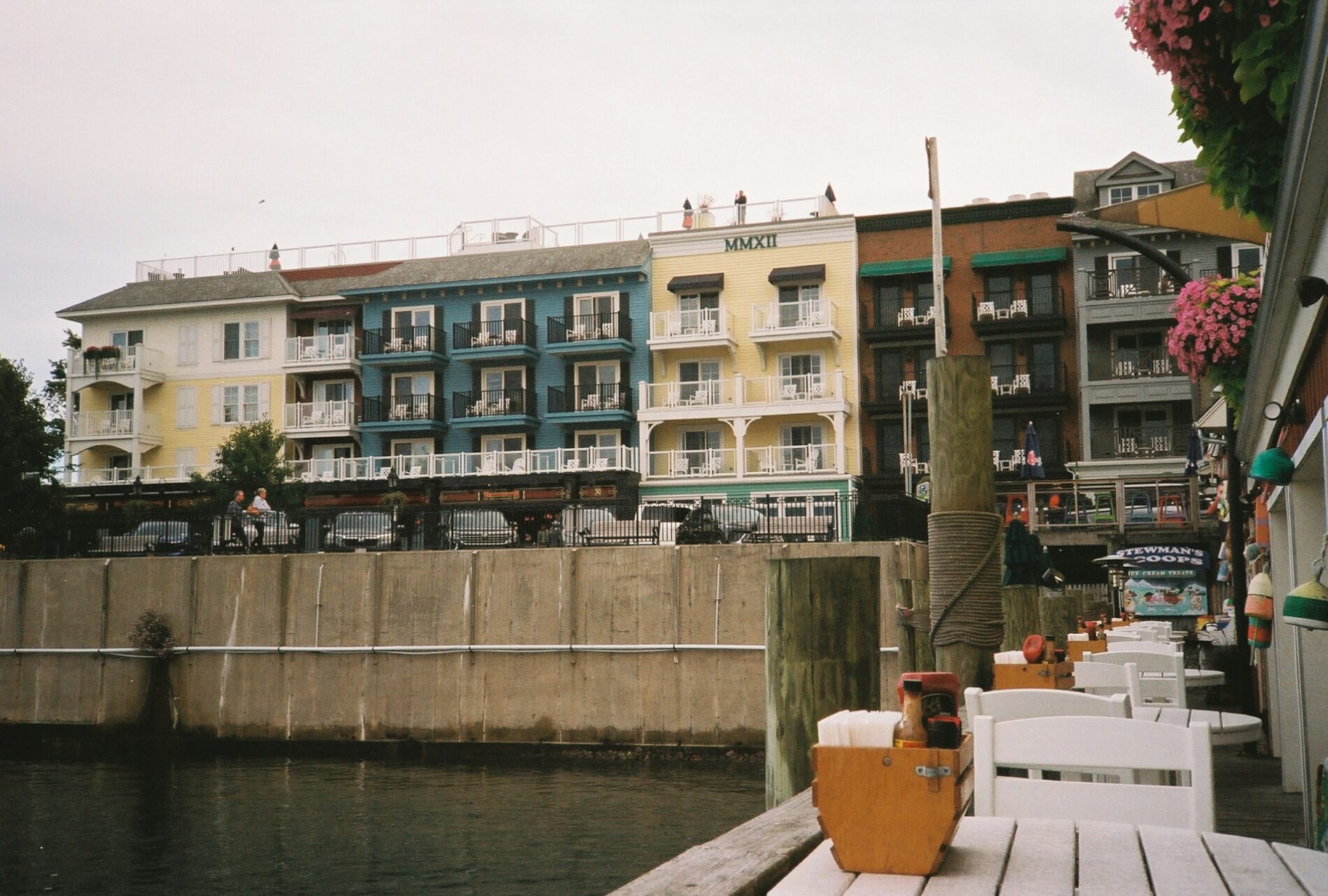 A seawall separates an apartment building from a harbour. 