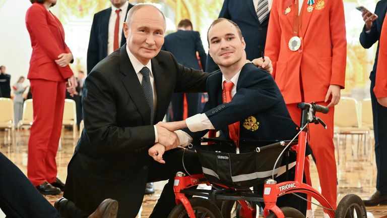 Vladimir Putin poses for a photo with two-time Paralympic silver medallist swimmer Vladimir Danilenko. File pic: Reuters