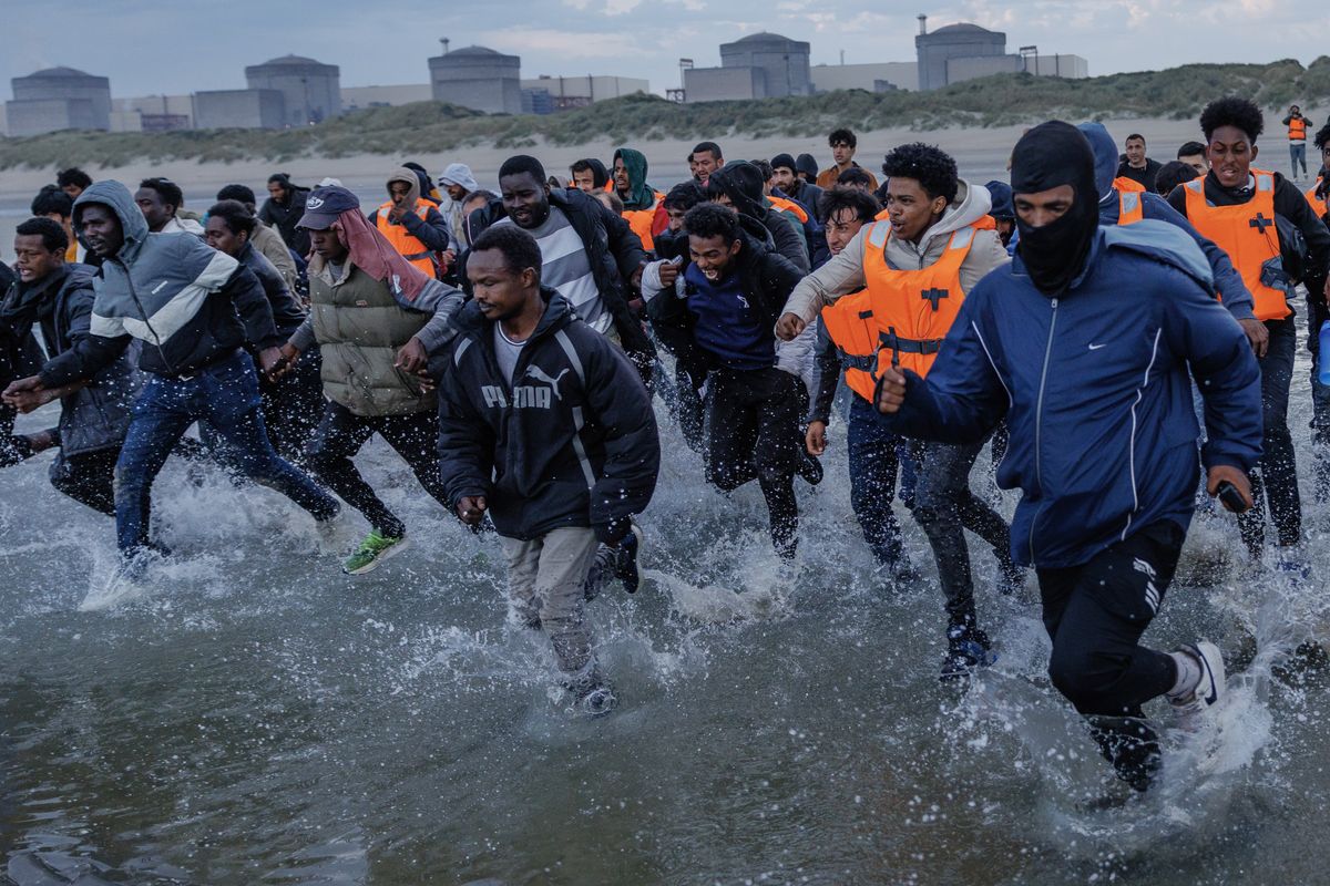 Small boat migrants on beach
