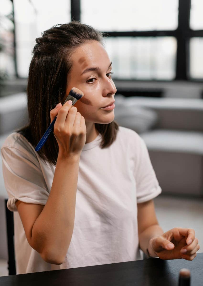 woman doing her makeup because she spends extra on an Ipsy subscription