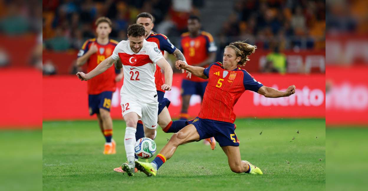 Turkey's Mustafa Eskihellac in action with Spain's Marcos Llorente. Photo: Reuters/Marcelo Del Pozo