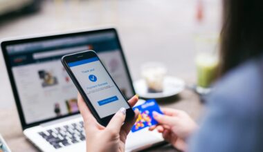 A woman making payment success on mobile smartphone screen and using credit card while shopping on online retail shop with laptop computer, accessed on Nov. 20, 2025. (Adobe Stock Photo)