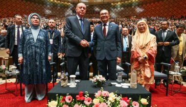 Malaysias PM Anwar Ibrahim (2nd R) shakes hands with President Recep Tayyip Erdogan  (2nd L) next to their wives Türkiyes first lady Emine Erdogan (L) and Malaysias Wan Azizah Wan Ismail (R) during a public lecture at the Putrajaya International Convention Centre in Putrajaya, Malaysia on Feb. 10, 2025. (AFP Photo)