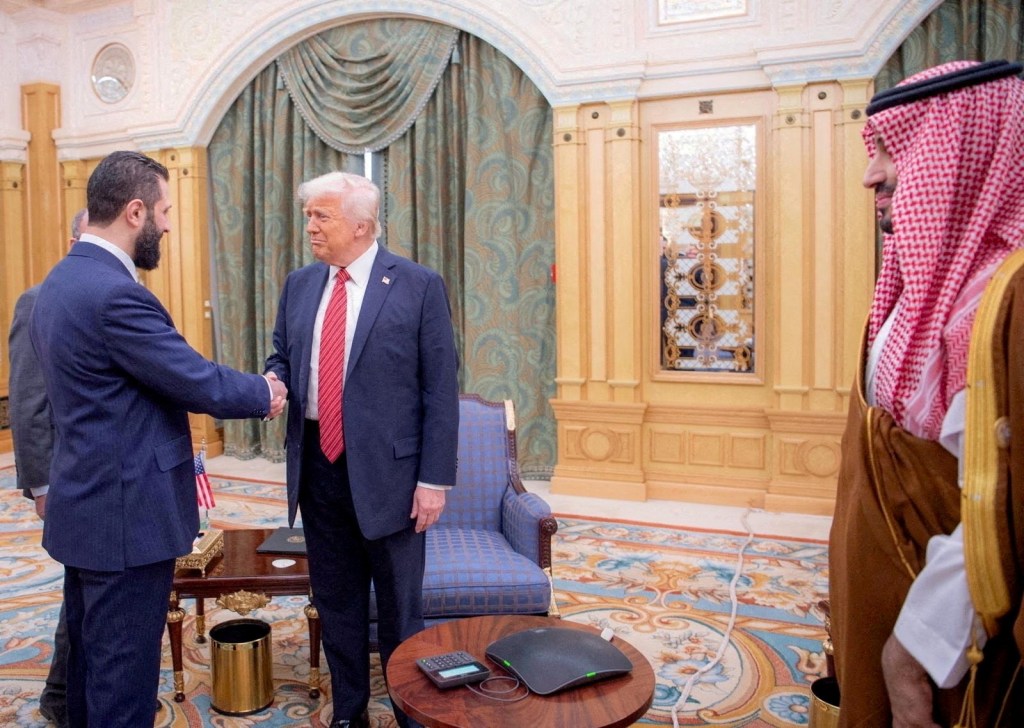 U.S. President Donald Trump shakes hands with Syrian President Ahmed al-Sharaa in Riyadh.